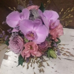 Felülről egy csokor, lila, rózsaszínű és zöld virágokkal.